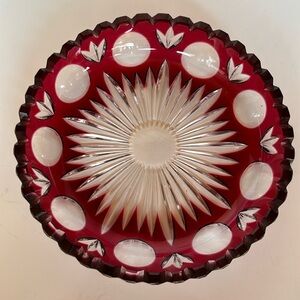 Red glass dish cut to clear. Thumbprint, leaf, and starburst design. 6” x 1.5”.